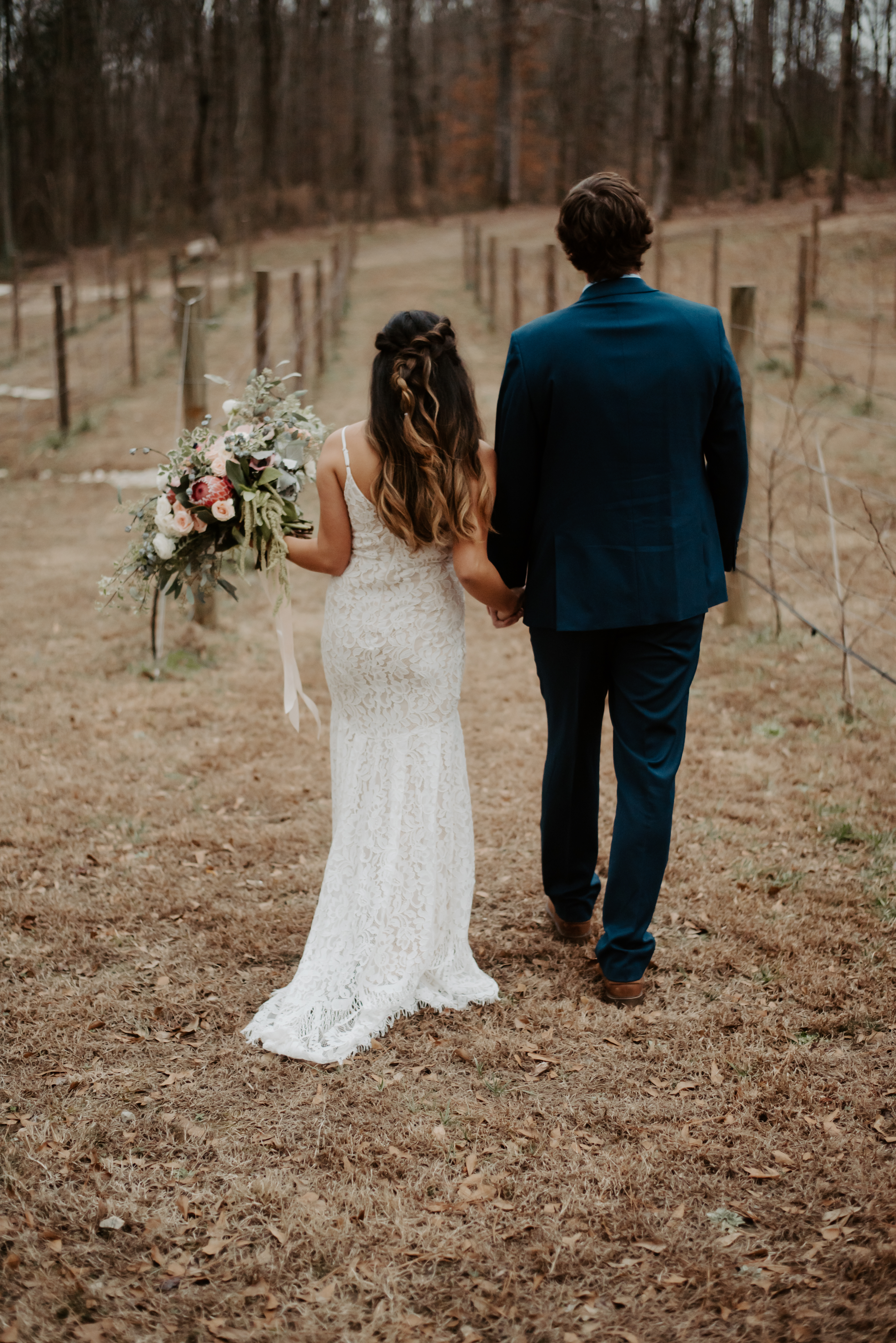 The vineyard was dried out but it still gave them a gorgeous background for their bohemian wedding flowers