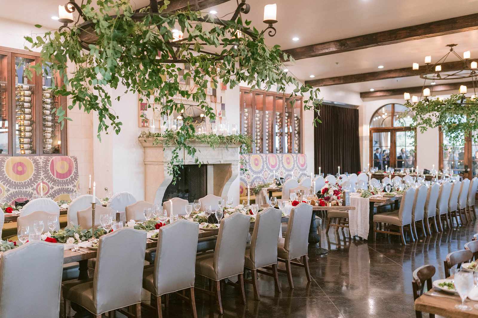 Interior restaurant styled for a wedding at Montaluce Winery featuring southern smilax and red flowers