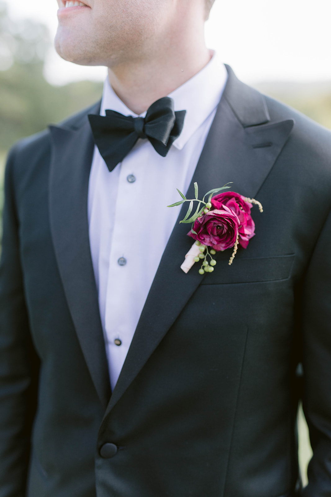 burgundy and blush boutonnière shown on the grooms suit montaluce winery wedding