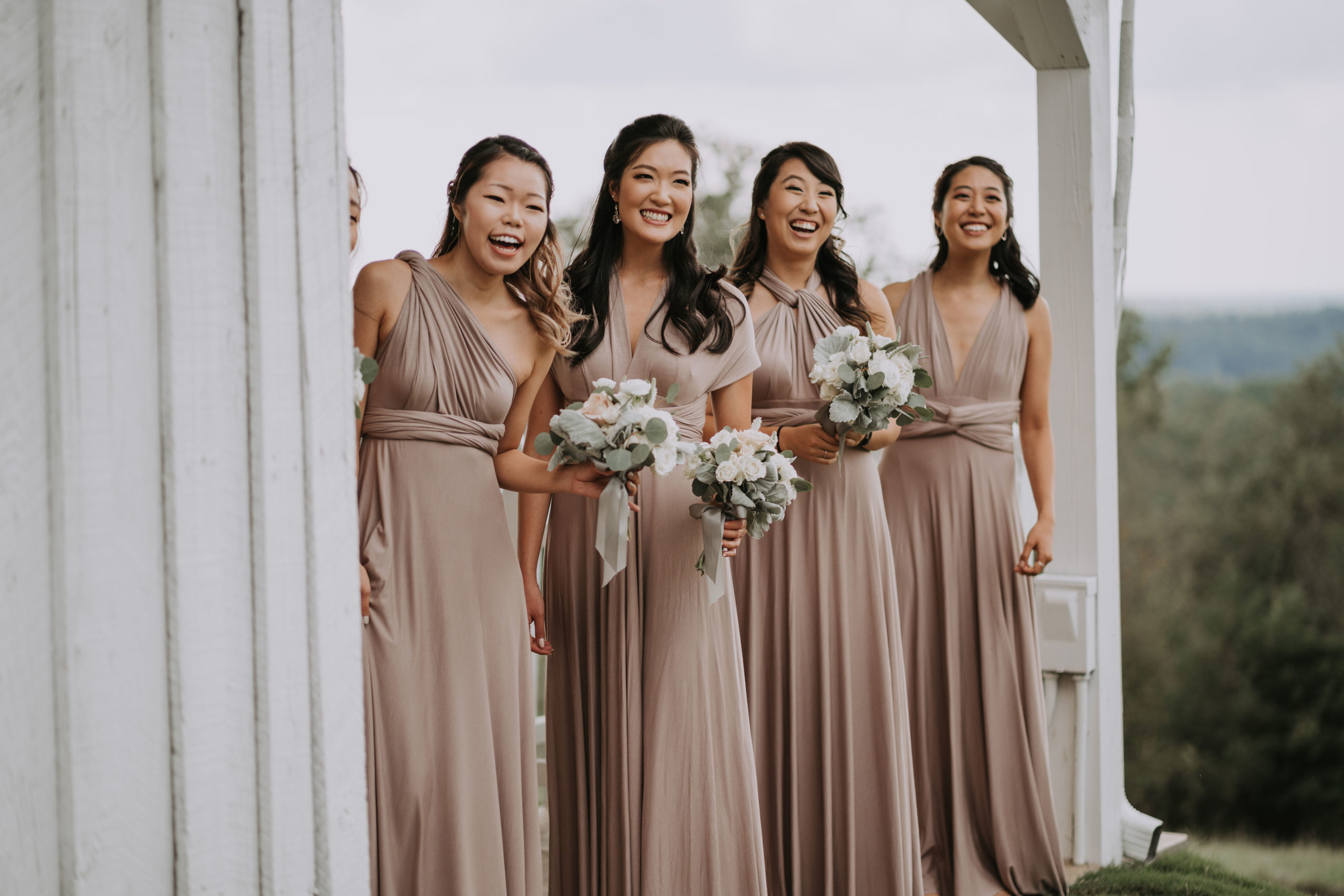 Bridesmaids holding blush bridesmaids bouquets