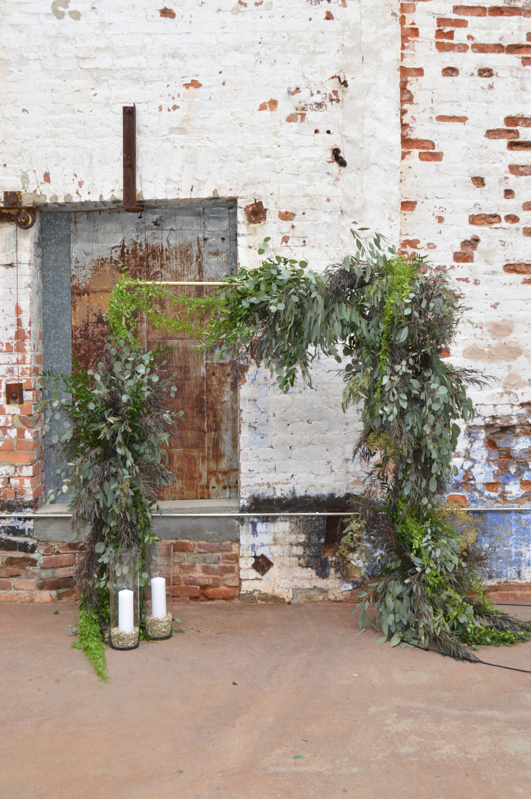 Industrial Wedding arch flowers with all greens 