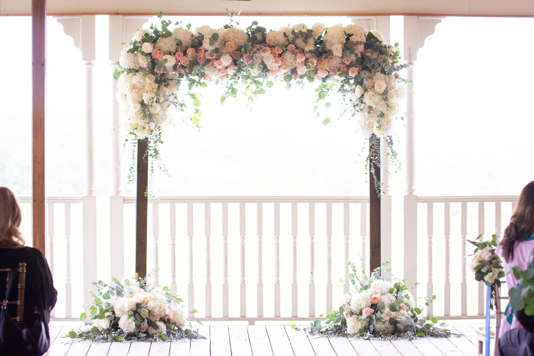 Lush wedding arch flowers with fluffy hydrangeas and roses