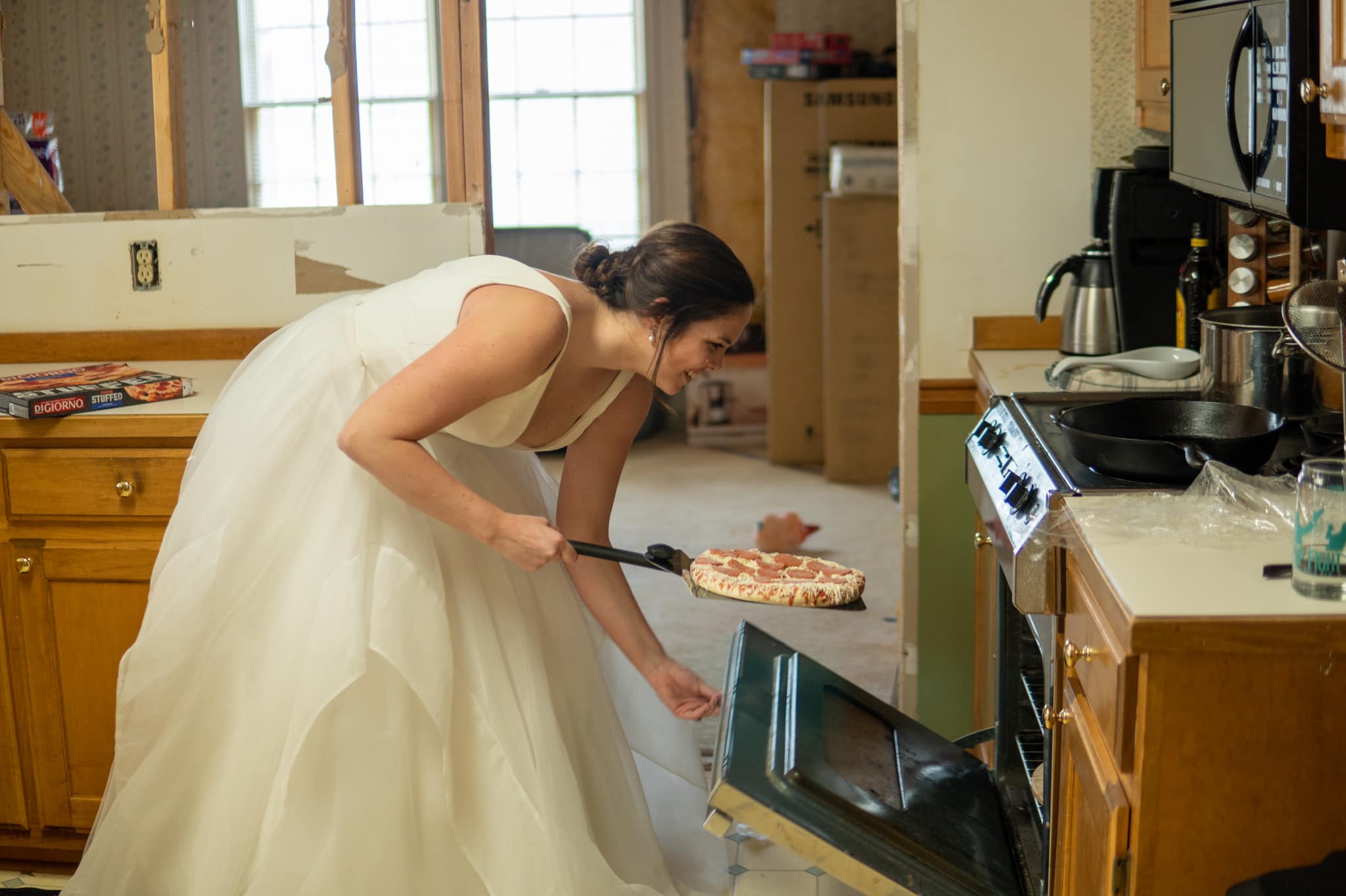 Bride making pizza for their wedding 