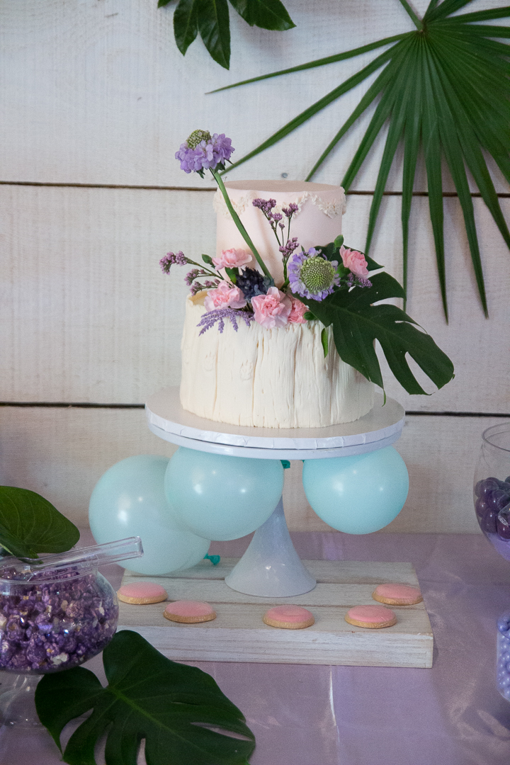 Koury Farms cake table with whimsical birthday cake with montera leaf, scabiosas, mini carnations and filler