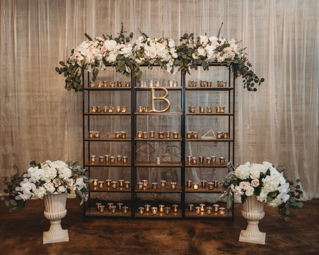 industrial chic wedding Shelving full of candles at the cotton mill event venue